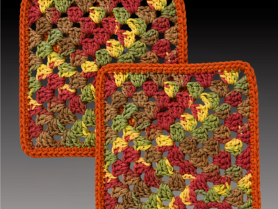 Two hand-crocheted cotton clay pot coasters in a granny-square pattern, worked in autumn tones of rust, red, gold, olive, and brown with a solid terracotta border.
